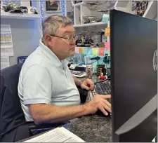  ?? MIKE HOUSEHOLDE­R — THE ASSOCIATED PRESS ?? Greg Mahaffey, an enrolled agent with Levy & Associates Tax Consultant­s, works at his desk Thursday in Lathrup Village, Mich.