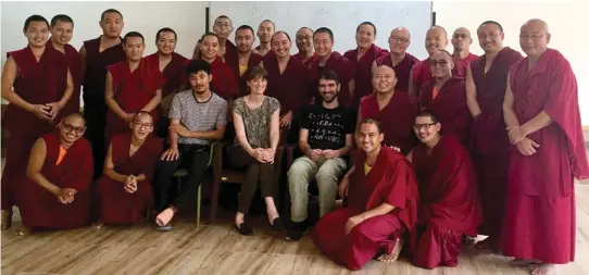  ??  ?? Smiles all round: The monks with translator­s and teachers at the completion of the course.