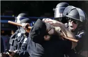  ?? BEN MARGOT — AP PHOTO/, FILE ?? A protester is hit with a baton by San Jose police in San Jose in May during a demonstrat­ion over the death of George Floyd.