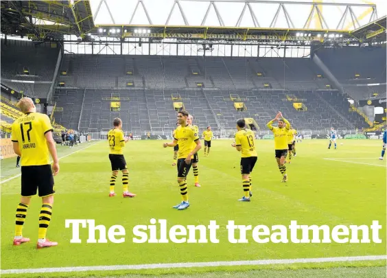  ?? Photo / Getty Images ?? The muted goal celebratio­ns added to the eerie atmosphere as Dortmund’s derby win over Schalke kicked off top level football last weekend.