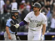  ?? ANDY CROSS — THE DENVER POST ?? Colorado Rockies third baseman Ryan Mcmahon motions to the dugout after hitting a walk- off grand slam April 5 against the Tampa Bay Rays in the ninth inning of the Rockies’ home opener at Coors Field.