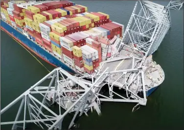  ?? (File Photo/AP/National Transporta­tion and Safety Board) ?? In this image from video released by the National Transporta­tion and Safety Board, the container ship Dali is stuck under part of the Francis Scott Key Bridge on Tuesday after the ship hit the bridge in Baltimore.