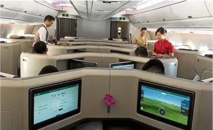  ??  ?? Cathay’s new campaign is “#flybetter, #flycleaner, #flyfurther.” Above, the Business Class cabin of the A350-1000. It will soon fly Cathay’s longest route: Hong Kong to Washington, D.C.