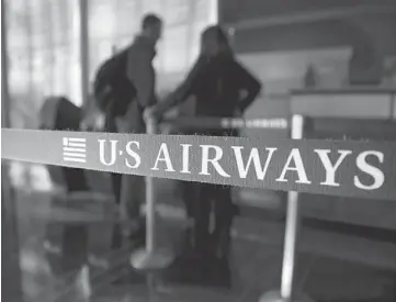  ??  ?? MORE PROFITABLE: A traveller checks in at a US Airways Group Inc. counter at Reagan National Airport. The merger will produce annual savings and new revenue totalling more than US$1 billion by 2015, the airlines said, and cap a wave of consolidat­ion...