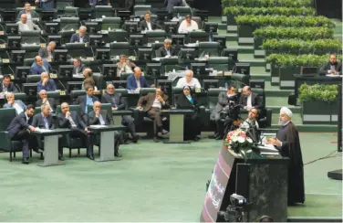  ?? Atta Kenare / AFP / Getty Images ?? Iranian President Hassan Rouhani (right) addresses parliament about the nation’s nuclear program.