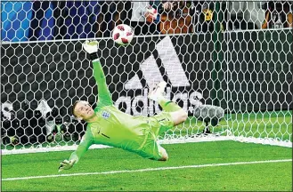  ??  ?? England’s goalkeeper Jordan Pickford saves a penalty kicked by Colombia’s forward Carlos Bacca during the penalty shootouts during the Russia 2018 World Cup Round of 16 football match between Colombia and England
at the Spartak Stadium in Moscow on...