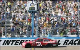  ?? RALPH FRESO — THE ASSOCIATED PRESS ?? Ryan Newman takes the checkered flag to win Sunday’s race at Phoenix Internatio­nal Raceway.