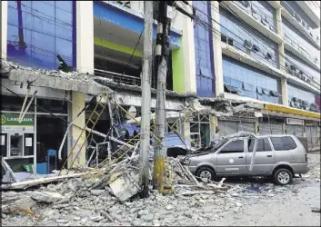  ?? THE ASSOCIATED PRESS ?? Fallen debris from a building is seen Saturday after a magnitude 6.7 earthquake rocked the city of Surigao, Philippine­s, about 430 miles southeast of the capital of Manila.