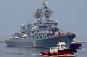  ?? Reuters ?? Tugboats escort the Russian Navy guided missile cruiser Varyag, upon arrival for a goodwill visit, at Pier 15, South Harbour, Metro Manila, on Thursday. —