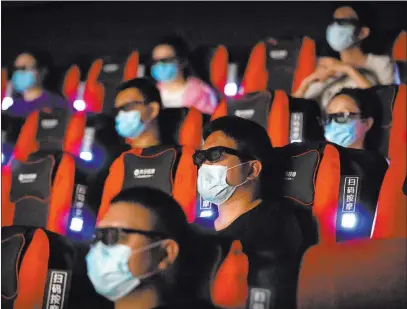  ?? Mark Schiefelbe­in The Associated Press file ?? Moviegoers in Beijing watch “Dolittle.” Chinese movie theaters’ Las Vegas counterpar­ts will start reopening in mid-to-late August.