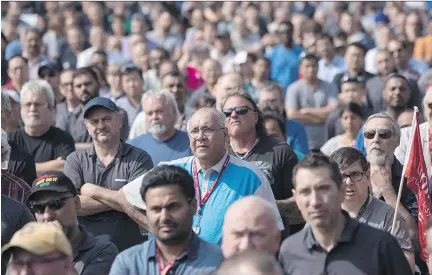  ?? CHRIS YOUNG/THE CANADIAN PRESS ?? Workers at a Bombardier plant in Toronto listen to Unifor national president Jerry Dias speak Wednesday amid mounting calls for Boeing to drop a trade complaint against Bombardier. Bombardier rejected claims that it is not co-operating with the probe.