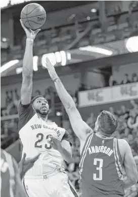  ?? Gerald Herbert / Associated Press ?? Forward Anthony Davis, left, didn’t have new addition DeMarcus Cousins when the Pelicans defeated Ryan Anderson and the Rockets a week ago.