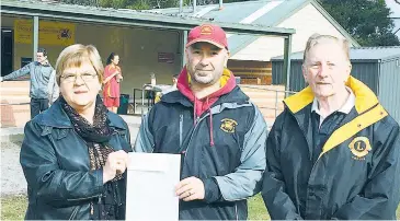  ??  ?? Drouin Dragons Soccer Club vice-president Jason Beer receives a donation for the club’s junior teams from Erika Wassenberg (left) and Don Sinclair (right) from the Drouin Lions Club.