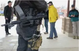  ?? MICHAEL B. THOMAS/AFP/GETTY IMAGES ?? “Open carry” gun activists participat­e in a march last weekend in Ferguson, Mo.