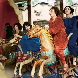  ??  ?? ALL THE FUN... Girls on a carousel at a funfair in Wembley, north London, June 1924