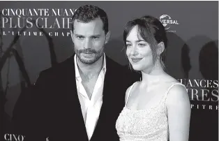  ?? THE ASSOCIATED PRESS ?? Jamie Dornan, left, and Dakota Johnson attend the world premiere of “Fifty Shades Freed” at Salle Pleyel in Paris on Tuesday.