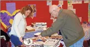  ?? / John Popham ?? Volunteer Allison Hunter, left, serves father-in-law and U.S. Navy Veteran Guy Hunter one of the 20 desserts made by East Central teachers for the Veterans Day Luncheon.