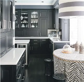  ?? VERN YIP/WASHINGTON POST ?? Transition­al black-and-white kitchens are rising in popularity. In this example, Omega’s transition­al Clio door style pairs with Cambria’s Ella quartz countertop­s for a fresh, yet timeless, look.