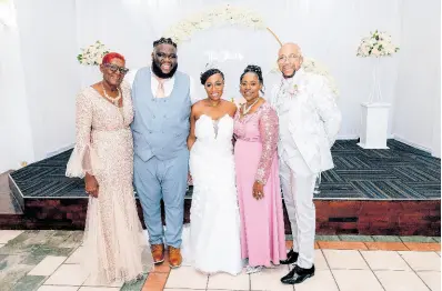  ?? ?? Surrounded by love, the bride and groom (centre) pose with their parents (from left) Ever Pryce, Julene Martin and Gary Martin.