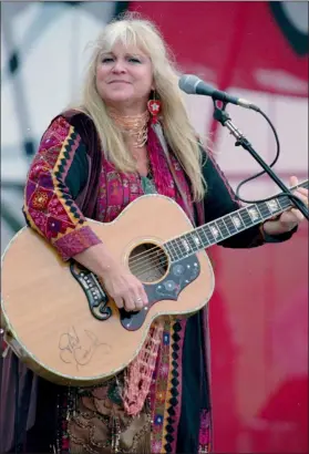  ?? KEN BIZZIGOTTI — THE ASSOCIATED PRESS FILE ?? Melanie Safka, who performed at the original Woodstock decades ago, opens the second day of the festival “Day In The Garden,” in Bethel, N.Y. She was just 22 when she performed at the historic 1969 concert that also included Jimi Hendrix, Grateful Dead and Joan Baez. Melanie had been waiting for hours and hours to perform, sitting on the side of the stage as she watched Richie Havens and others complete their sets.