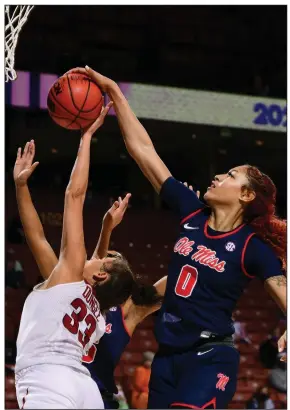  ?? (Photo courtesy of the SEC) ?? Ole Miss senior forward Shakira Austin (0) blocks a shot by Arkansas’ Chelsea Dungee during the Rebels’ victory over the Razorbacks on Thursday night at the SEC Women’s Tournament in Greenville, S.C. Austin finished with 29 points, 13 rebounds and 3 blocks.