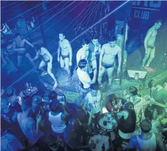  ??  ?? BEEFCAKE: Dancers on stage at ZAG bar in Phuket. Thailand’s famously loud and proud gay party scene is a magnet for Chinese homosexual­s escaping judgement at home.