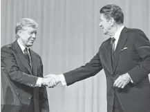 ?? Associated Press ?? President Jimmy Carter and Republican presidenti­al candidate Ronald Reagan were cordial to each other after their debate on Oct. 28, 1980, in Cleveland.