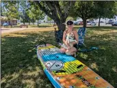  ?? ?? Adie Cunningham talks about the nice weather with her pup Bentley while she inflates her paddleboar­d to take out onto Lake Oroville in Butte County, California on Monday.