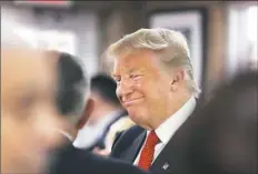  ?? Spencer Platt/Getty Images ?? Republican presidenti­al nominee Donald Trump stops by a coffee shop Tuesday after speaking at Miami Dade College in Miami, Fla.