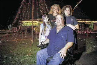  ?? BRUCE R. BENNETT / THE PALM BEACH POST ?? Tony and Dawn Lasky, with their children, Krystal and Ryan, are proud of their home. “Every time I see a kid coming through here ... it brings me joy,” Tony says.