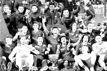  ??  ?? Paris St Germain players celebrate with the trophy after their victory in the Coupe de la Ligue Final match at Matmut Atlantique Stadium, Bordeaux, France. — Reuters photos