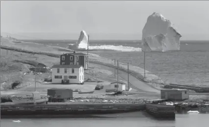  ?? PAUL DALY, THE CANADIAN PRESS ?? A large iceberg is visible from the shore in Ferryland, an hour south of St. John’s, N.L., on Monday.