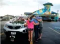  ?? THE ASSOCIATED PRESS ?? People pray by a car thought to belong to a victim of Thursday’s boating accident in Branson, Mo.