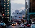  ?? Bloomberg photo by David Ryder ?? Traffic moves through downtown Anchorage, Alaska.