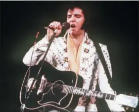  ?? THE ASSOCIATED PRESS ?? In this 1973file photo, Elvis Presley sings during a concert. A private jet once owned by Elvis Presley that has sat on a runway in NewMexico for nearly four decades is back on the auction block. The online auction site IronPlanet announced this week...