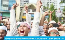  ??  ?? DHAKA: Muslim demonstrat­ors shout slogans as they take part in a protest yesterday, a day after deadly clashes when police shot at Bangladesh­i Muslims protesting Facebook messages that allegedly defamed the Prophet Mohammed (PBUH). — AFP