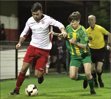  ??  ?? Rock’s Jamie McCaul breaks away from Navan’s Ronan Clarke.