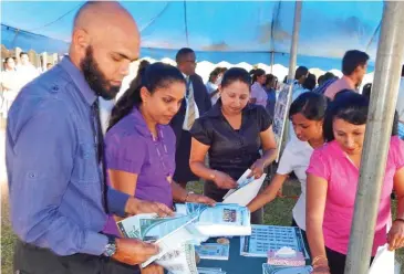  ?? Photo: Parliament of Fiji ?? Labasa College Teachers collecting their educationa­l materials on display.