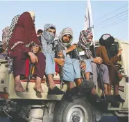  ?? WAKIL KOHSAR / AFP VIA GETTY IMAGES ?? Taliban fighters in a vehicle patrol Kabul on Monday.