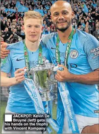  ??  ?? JACKPOT: Kevin De Bruyne (left) gets his hands on the trophy with Vincent Kompany