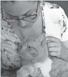  ?? JOHN R. CRANE/DANVILLE REGISTER & BEE VIA AP ?? Apollo, a 1-year-old cat, has found a loving home with Fallon Phillips in Pittsylvan­ia County, Va., after he received much-needed surgery. A Gofundme campaign raised more than $2,000 to help pay for the procedure.