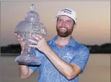  ?? AP photo ?? Chris Kirk holds the trophy after winning the Honda Classic in a playoff against Eric Cole on Sunday.