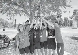  ?? ?? The Ferguson boys tennis team hoists up the GMAC championsh­ip trophy after winning its first title in the event on Tuesday at Crandon Park.