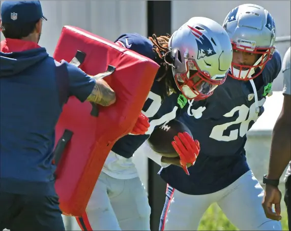  ?? STAFF PHOTO — CHRIS CHRISTO/BOSTON HERALD ?? New England Patriots defenders Quandre Mosely and Shaun Wade work through a drill during practice at Gillette Stadium on Aug. 23.