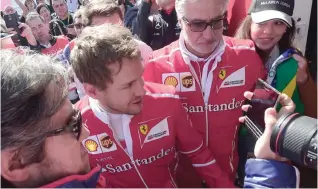  ?? — AFP ?? Ferrari’s German driver Sebastian Vettel (L) walks beside Ferrari’s Managing Director and Team Principal Maurizio Arrivabene (R) at the Circuit de Catalunya in Montmelo on the outskirts of Barcelona during the first day of the first week of tests for...