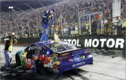  ?? WADE PAYNE — THE ASSOCIATED PRESS ?? Kyle Busch sweeps the top of his car after winning the NASCAR Cup Series race, Saturday Busch won the NASCAR Trucks,Xfinity and Cup races this week at the track. in Bristol, Tenn.