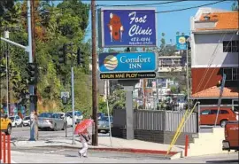  ?? Gary Coronado Los Angeles Times ?? A LOT of people are shocked to learn that the Happy Foot Sad Foot sign at Sunset and Benton is associated with an actual foot clinic. It’s run by Dr. Thomas Lim.