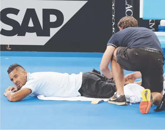  ??  ?? Nick Kyrgios is treated for an injury to his leg in his match against his compatriot Matthew Ebden at the Brisbane Internatio­nal.