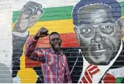 ?? Tsvangiray­i Mukwazhi / Associated Press ?? Terrence Chari mimics a painting of Zimbabwean President Robert Mugabe. Zimbabwean­s have become frustrated by the political standoff.