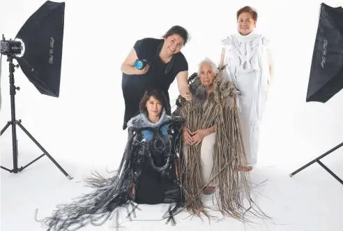  ?? Picture: ANNA ROGERS ?? FAMILY TIES: Grace Lillian Lee explores the evolution of the weave in a Cairns Art Gallery exhibition featuring wearable art worn by her cousin Rachael Yelland (left), grandmothe­r Marcella Lee (seated) and aunt Rasma Yelland.